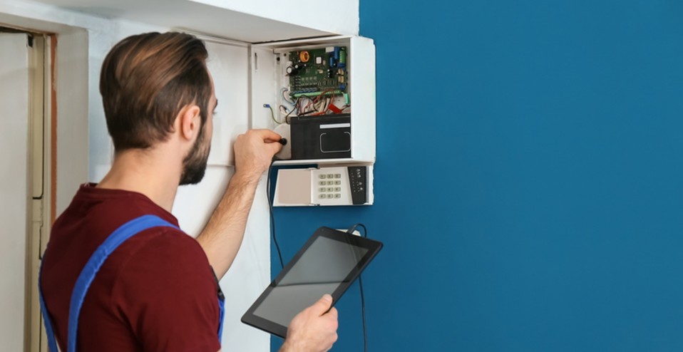 Representative technician servicing a security control panel